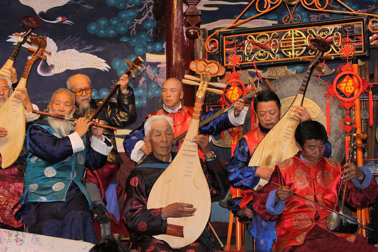 People playing the Naxi instruments